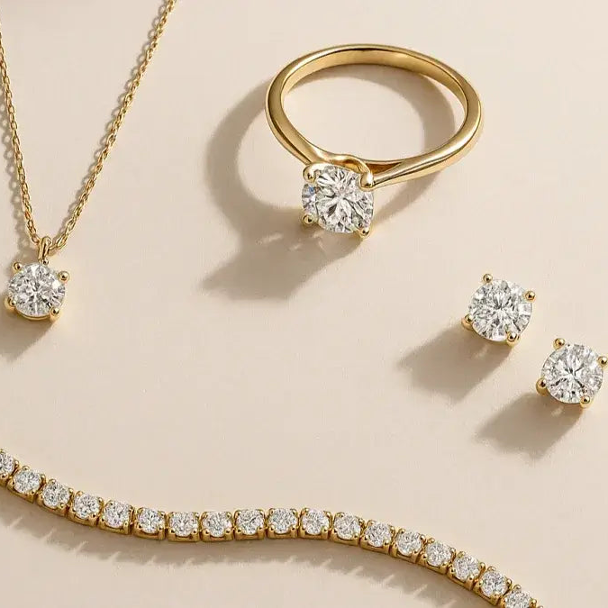 Gold jewelry set with necklace, ring, and earrings on a beige background