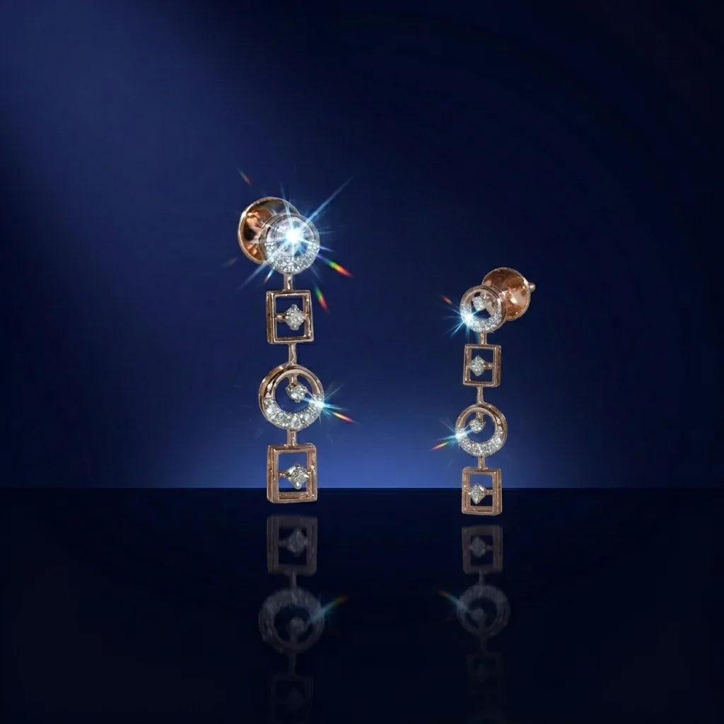 Pair of gold and diamond earrings on a dark blue background