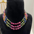 A multi-color beaded necklace displayed on a mannequin, featuring multiple strands and an adjustable dori.
