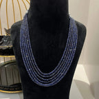 A multi-strand 6 layer blue sapphire beads necklace displayed on a black mannequin bust.