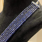 A multi-strand 6 layer blue sapphire beads necklace displayed on a black mannequin bust.
