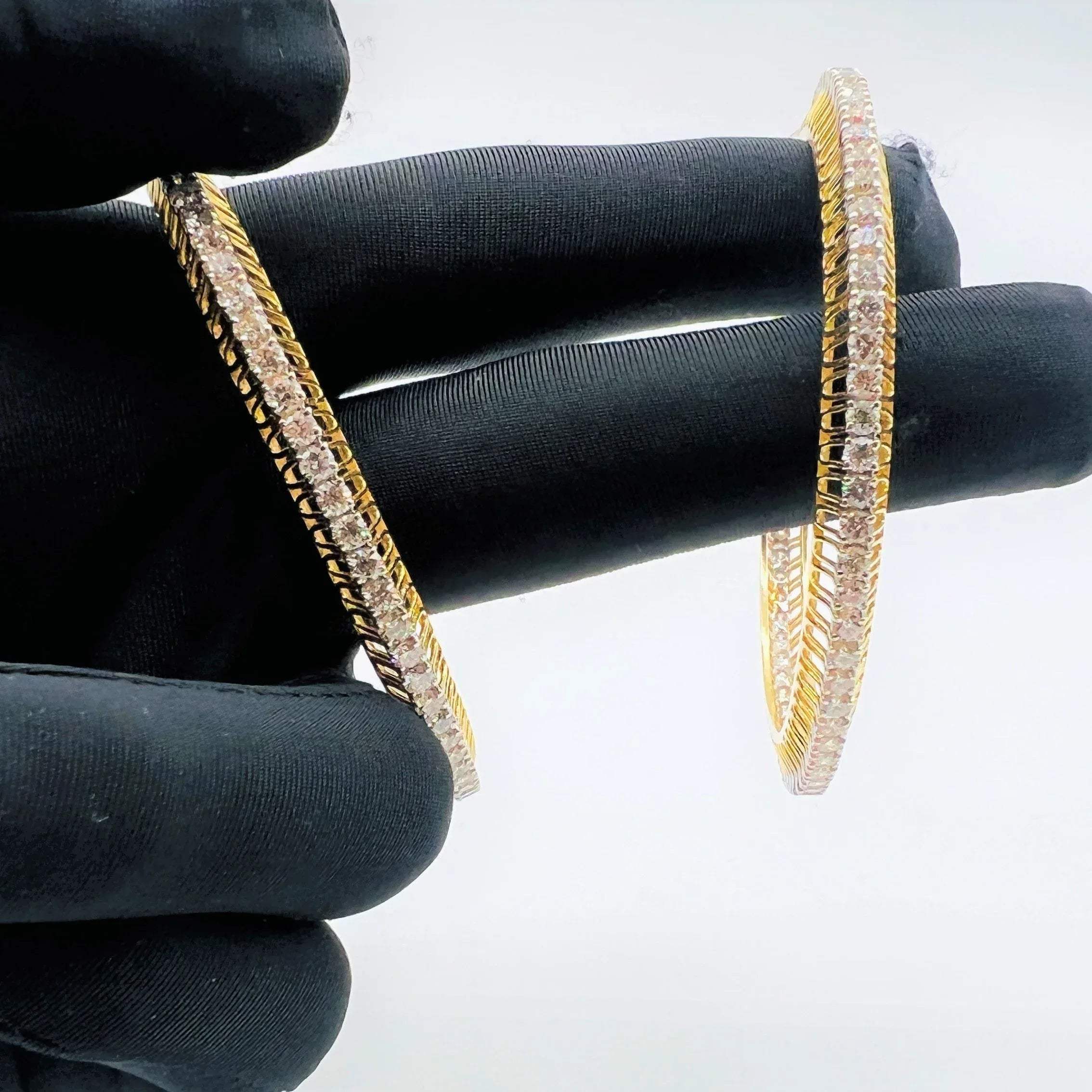 A beautiful gold diamond bangle pair with neatly set sparkling diamonds all around. The elegant design gives a timeless and classy look, making it perfect for everyday wear or special occasions.