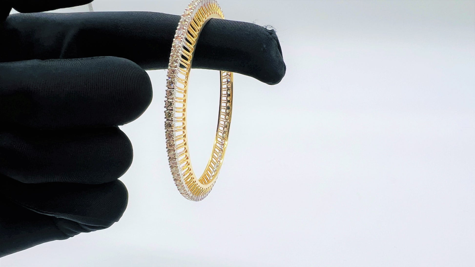 A beautiful gold diamond bangle pair with neatly set sparkling diamonds all around. The elegant design gives a timeless and classy look, making it perfect for everyday wear or special occasions.
