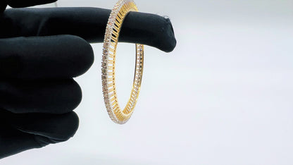 A beautiful gold diamond bangle pair with neatly set sparkling diamonds all around. The elegant design gives a timeless and classy look, making it perfect for everyday wear or special occasions.