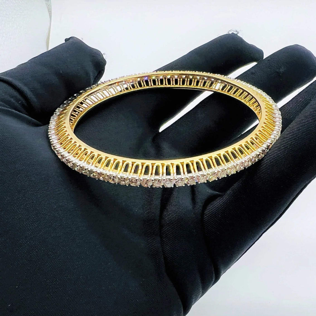 A beautiful gold diamond bangle pair with neatly set sparkling diamonds all around. The elegant design gives a timeless and classy look, making it perfect for everyday wear or special occasions.