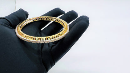A beautiful gold diamond bangle pair with neatly set sparkling diamonds all around. The elegant design gives a timeless and classy look, making it perfect for everyday wear or special occasions.