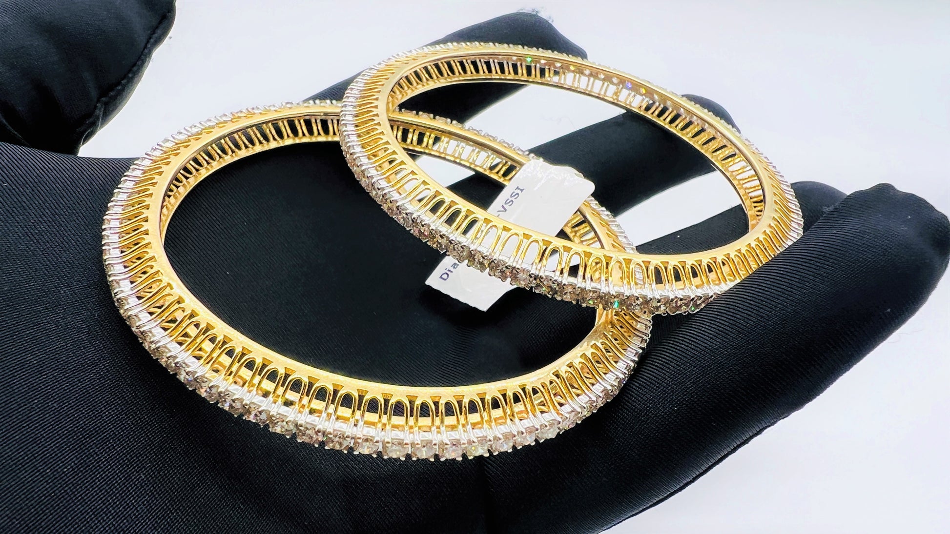 A beautiful gold diamond bangle pair with neatly set sparkling diamonds all around. The elegant design gives a timeless and classy look, making it perfect for everyday wear or special occasions.
