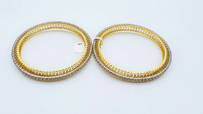 A beautiful gold diamond bangle pair with neatly set sparkling diamonds all around. The elegant design gives a timeless and classy look, making it perfect for everyday wear or special occasions.