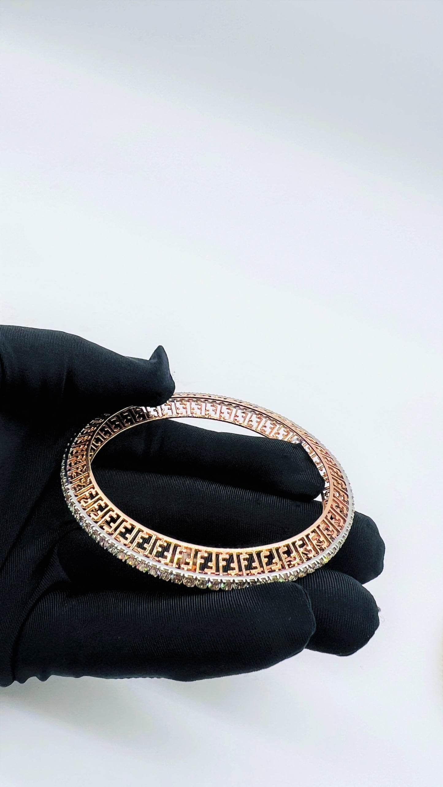 Zoom out view of rose gold diamond bangle set featuring fine diamond lining and modern cutwork design in 14k gold.