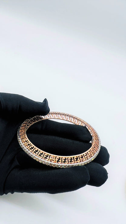 Zoom out view of rose gold diamond bangle set featuring fine diamond lining and modern cutwork design in 14k gold.