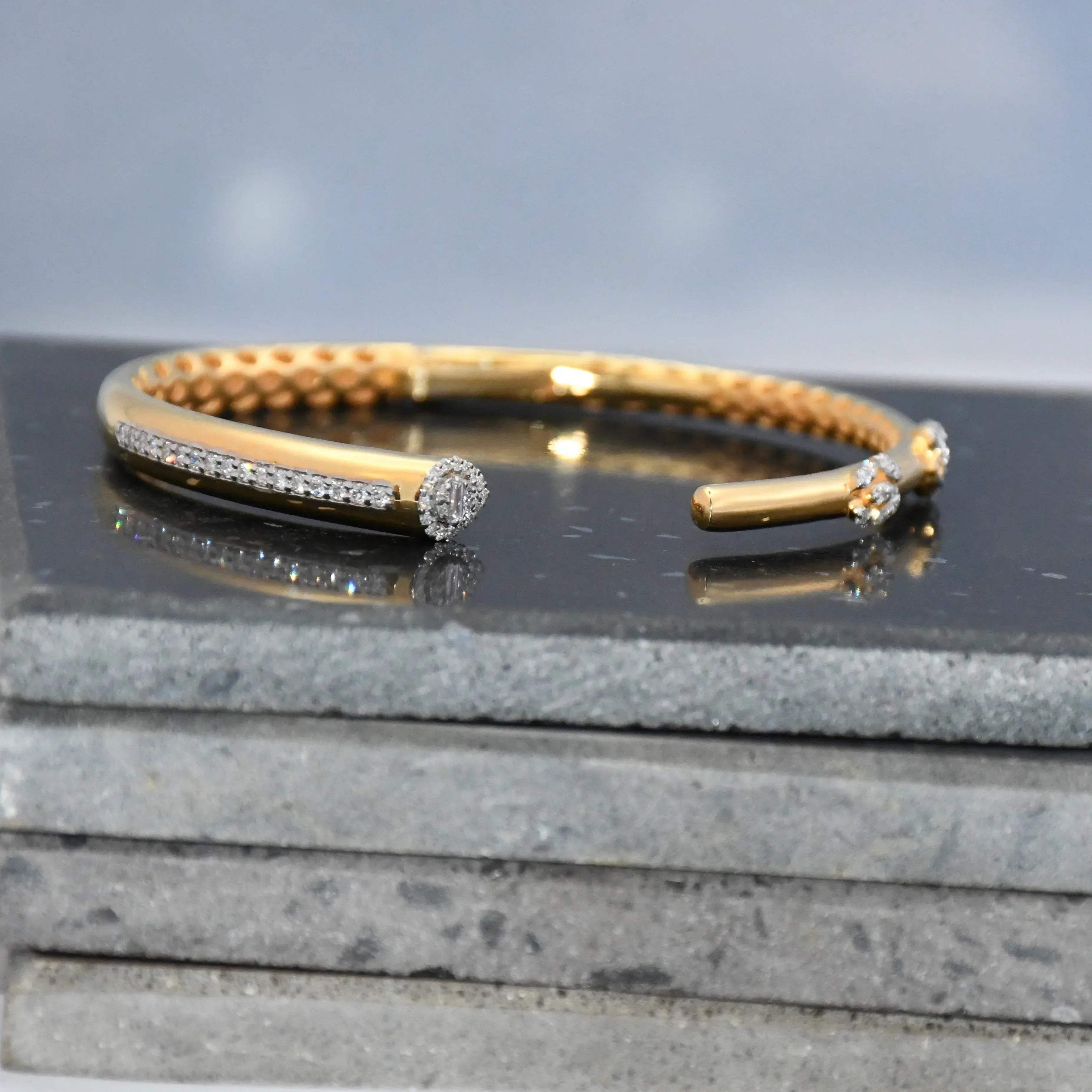 Gold bracelet with real diamonds on a dark surface