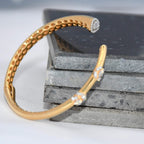 Gold bracelet with real diamond accents on a textured surface