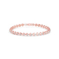 Rose gold bracelet with small diamonds on a white background