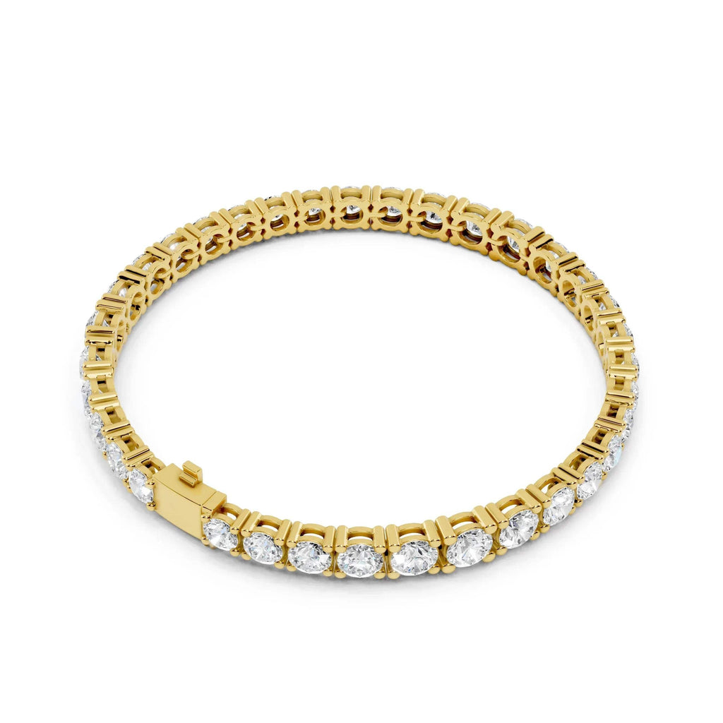 Yellow gold bracelet with diamond accents on a white background