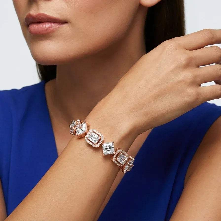 Close-up of a woman's wrist wearing a rose gold bracelet with real diamonds against a blue background
