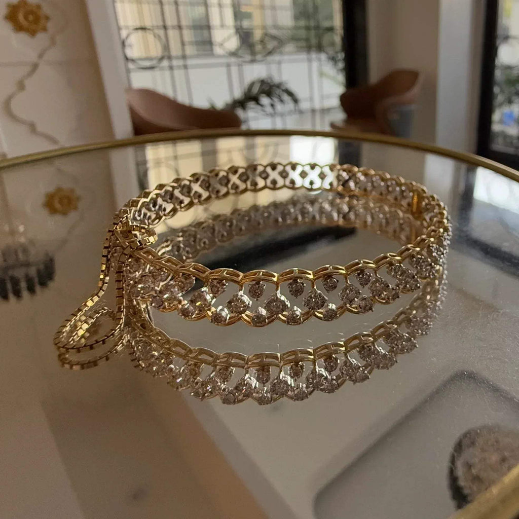 A luxurious diamond gold tennis bracelet with openable sections, featuring gold color and adorned with genuine diamonds, displayed on a glass.