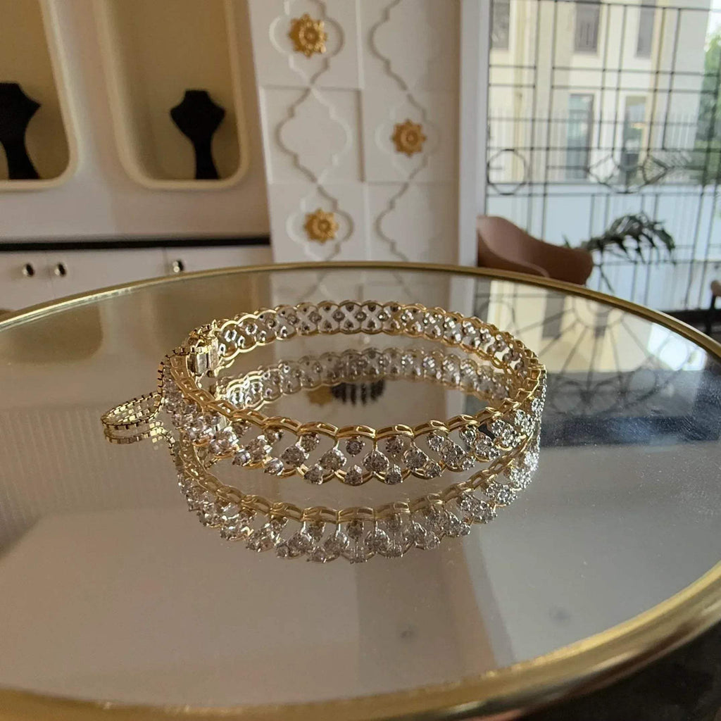 A luxurious diamond gold tennis bracelet with openable sections, featuring gold color and adorned with genuine diamonds, displayed on a glass.
