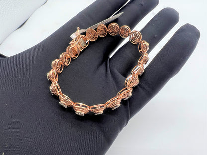 A gold diamond bracelet with multiple rows of inset stones, displayed on a mannequin hand.