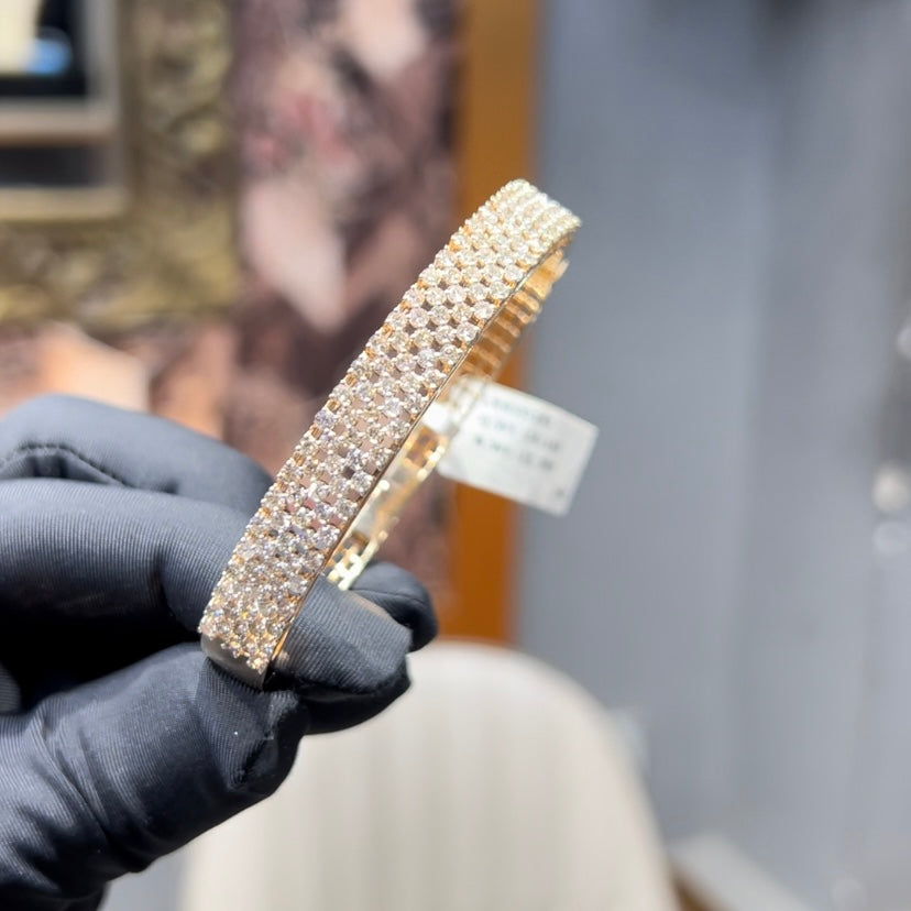 Elegant pavé set gold diamond bracelet with multiple rows of sparkling round-cut diamonds.