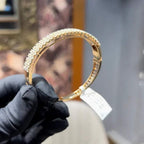 Elegant pavé set gold diamond bracelet with multiple rows of sparkling round-cut diamonds.