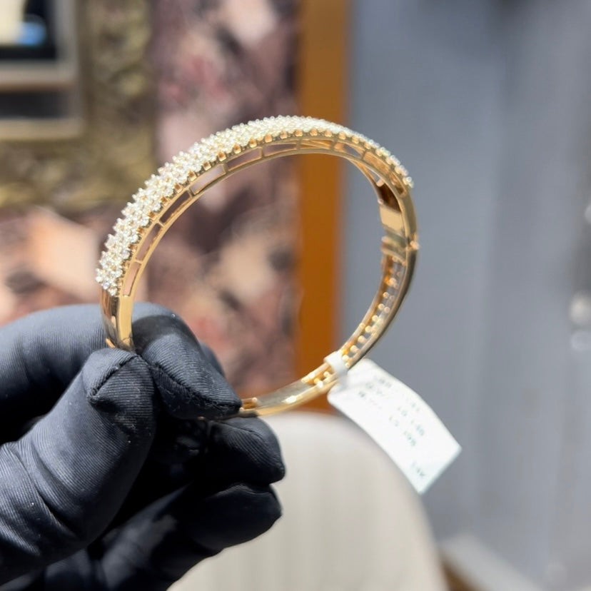 Elegant pavé set gold diamond bracelet with multiple rows of sparkling round-cut diamonds.