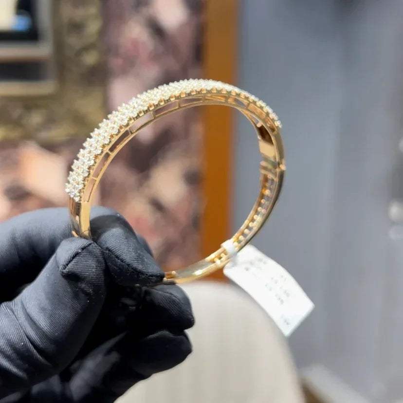 Elegant pavé set gold diamond bracelet with multiple rows of sparkling round-cut diamonds.