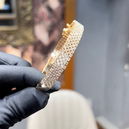 Elegant pavé set gold diamond bracelet with multiple rows of sparkling round-cut diamonds.