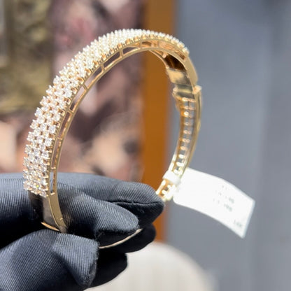 Elegant pavé set gold diamond bracelet with multiple rows of sparkling round-cut diamonds.