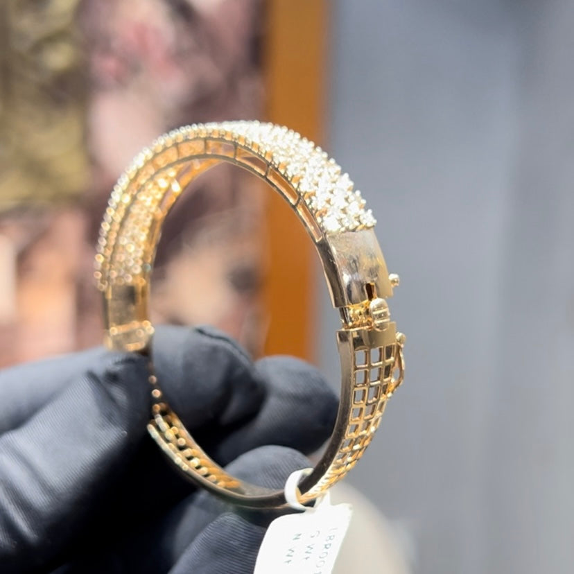 Elegant pavé set gold diamond bracelet with multiple rows of sparkling round-cut diamonds.