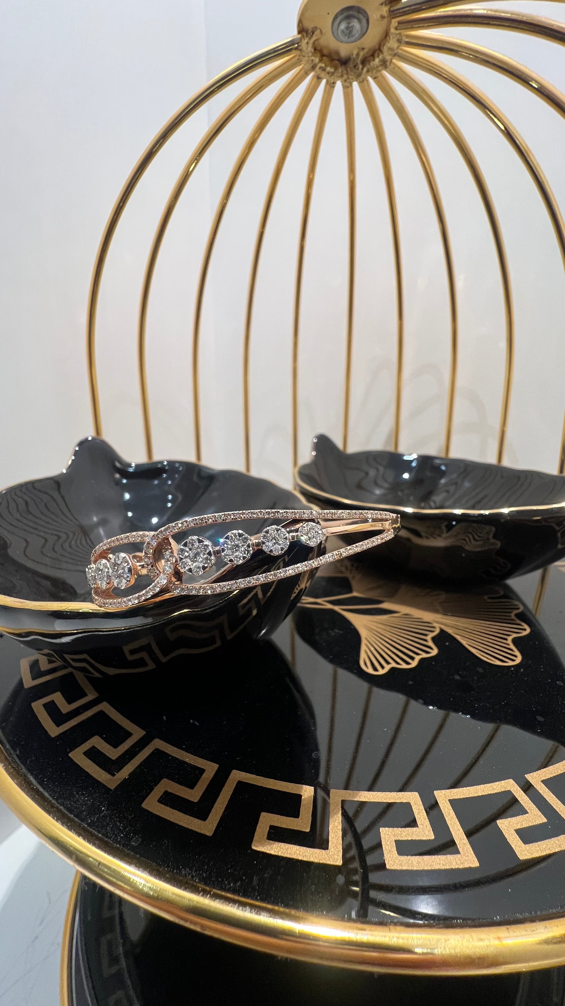 Gold diamond bracelet with round brilliant cut diamonds in chain-link bangle design displayed on luxury background.