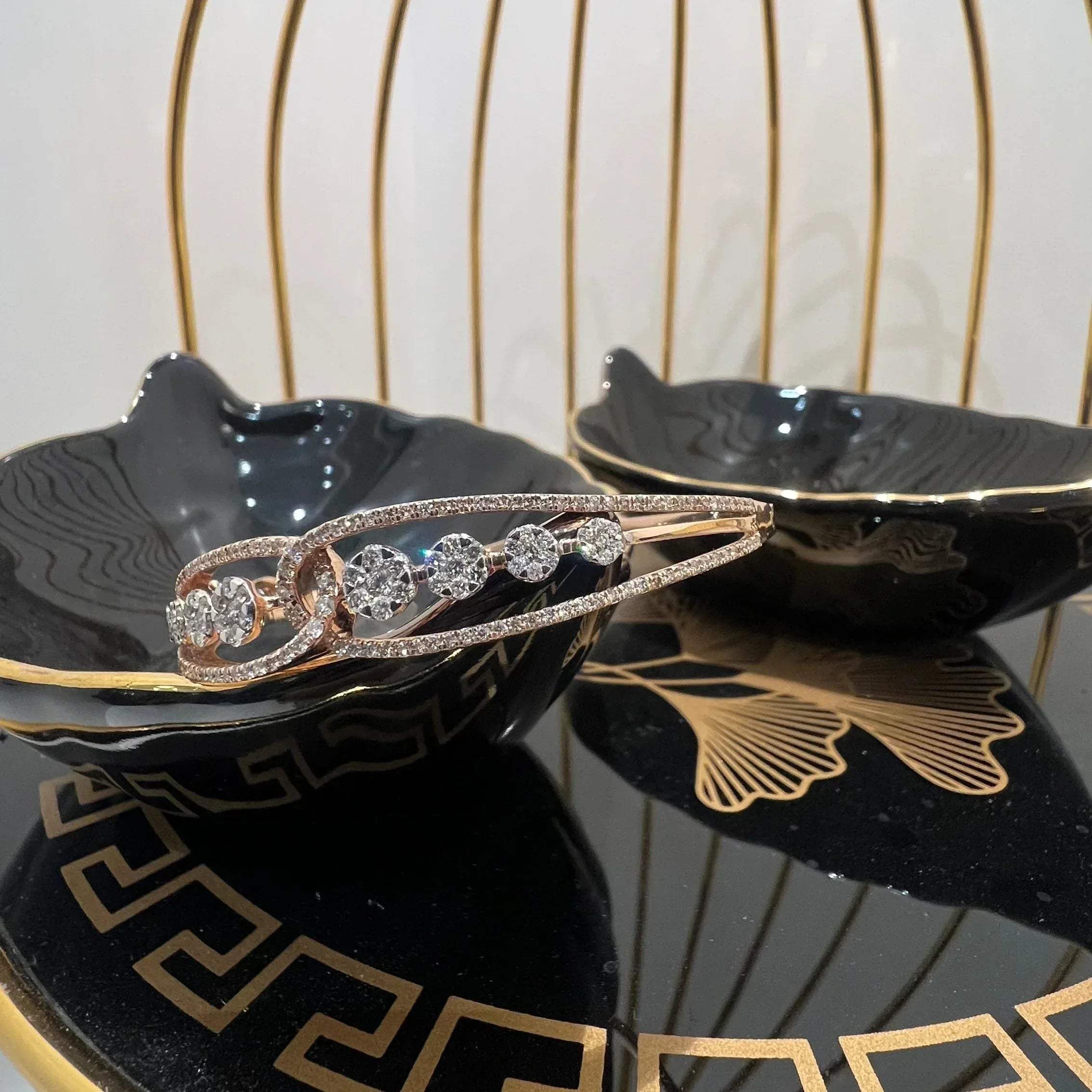 Gold diamond bracelet with round brilliant cut diamonds in chain-link bangle design displayed on luxury background.