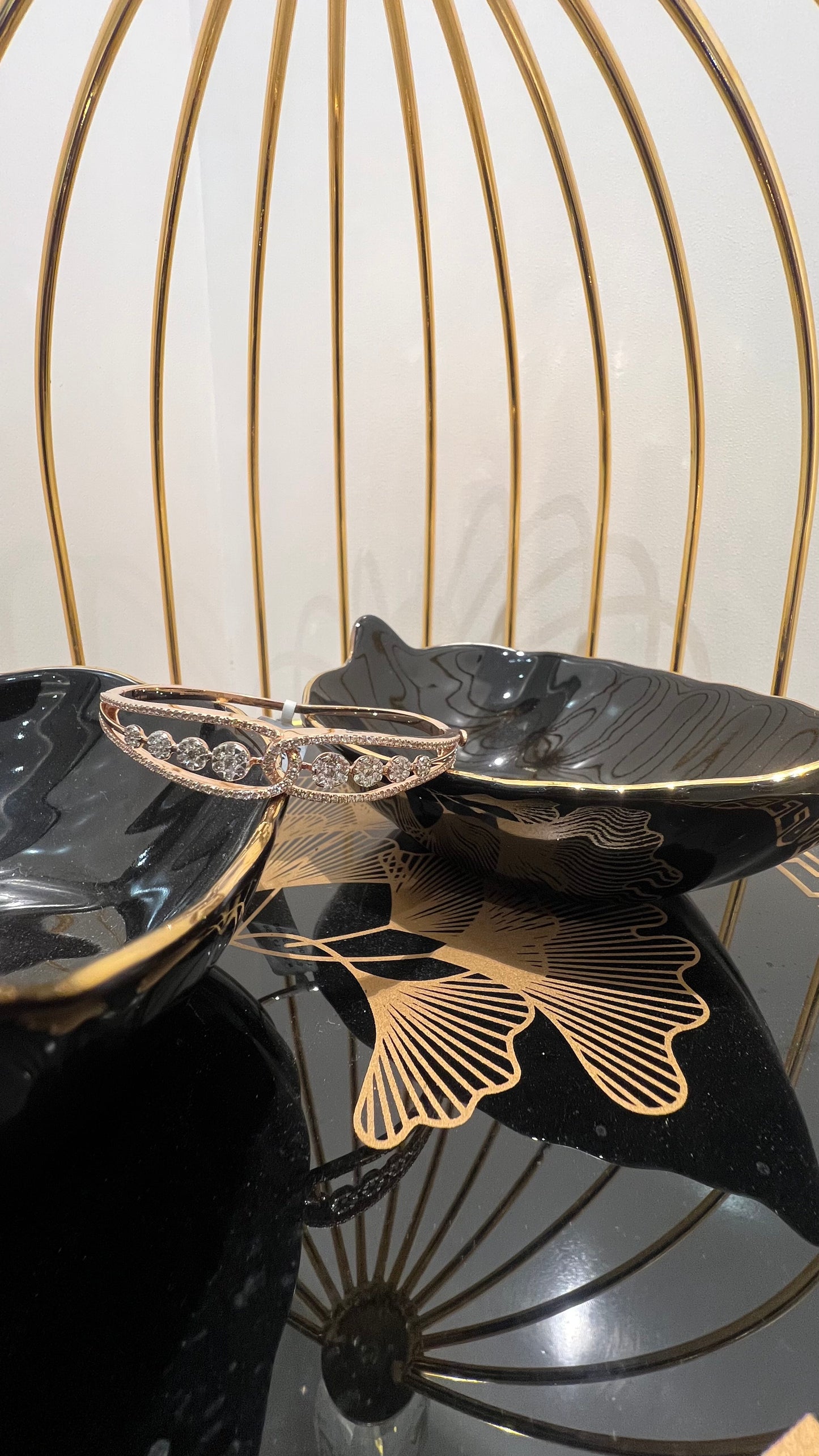 Gold diamond bracelet with round brilliant cut diamonds in chain-link bangle design displayed on luxury background.