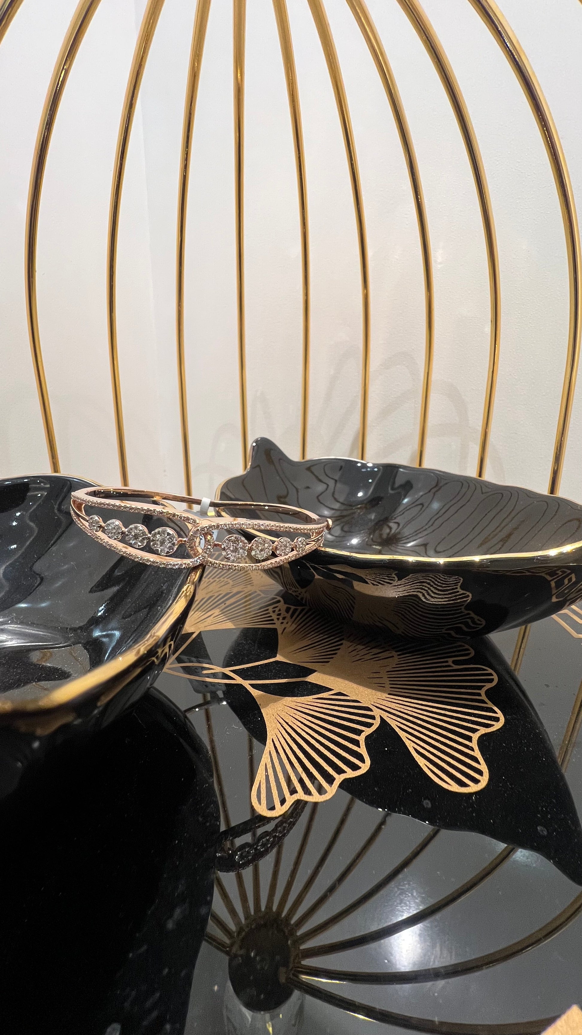 Gold diamond bracelet with round brilliant cut diamonds in chain-link bangle design displayed on luxury background.