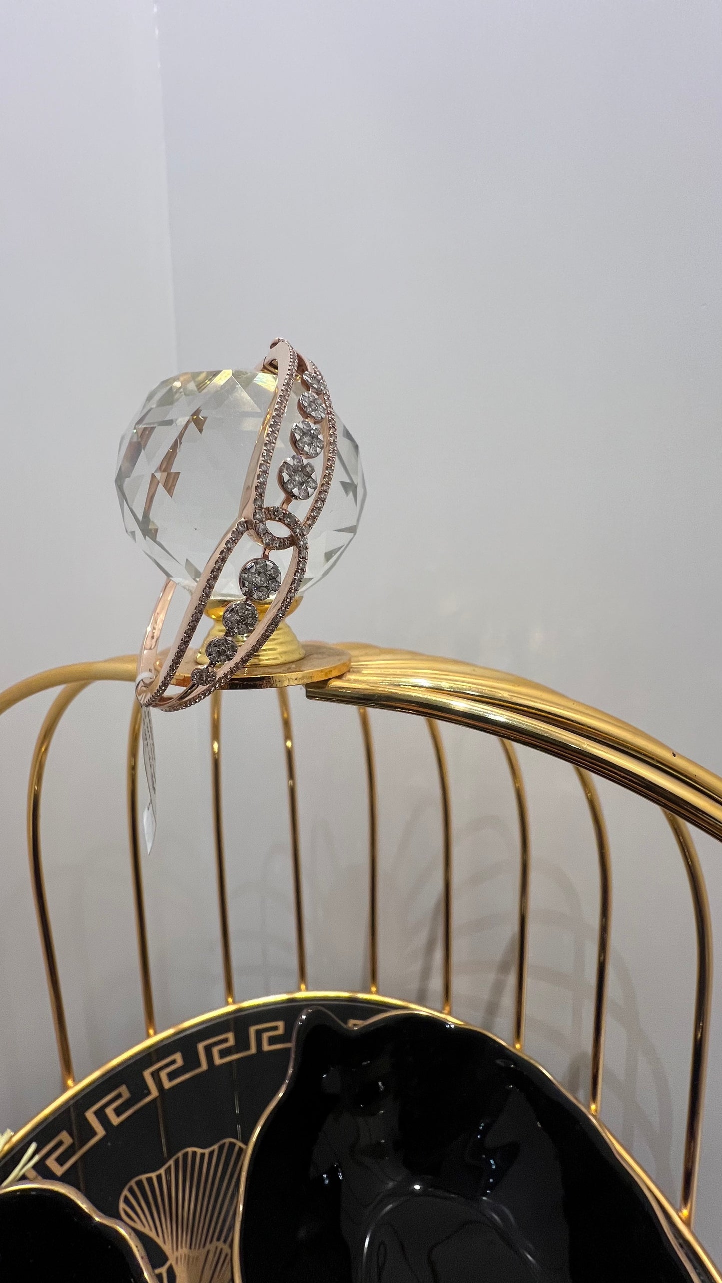 Gold diamond bracelet with round brilliant cut diamonds in chain-link bangle design displayed on luxury background.