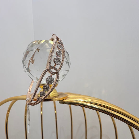 Gold diamond bracelet with round brilliant cut diamonds in chain-link bangle design displayed on luxury background.