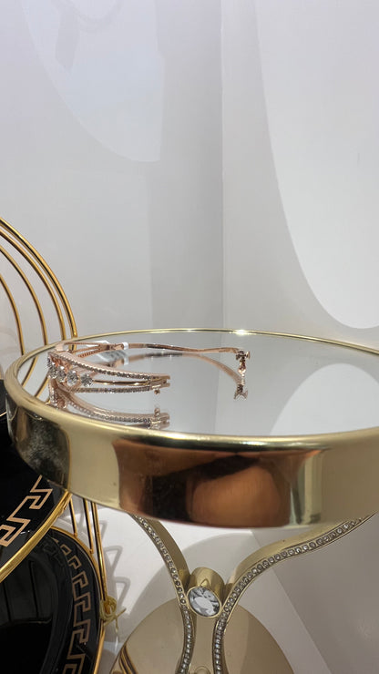 Gold diamond bracelet with round brilliant cut diamonds in chain-link bangle design displayed on luxury background.