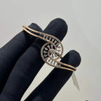 A luxurious gold diamond bracelet with a openable design, featuring a central oval-shaped diamond surrounded by smaller diamonds set in a brilliant cut, displayed on a mannequin hand.