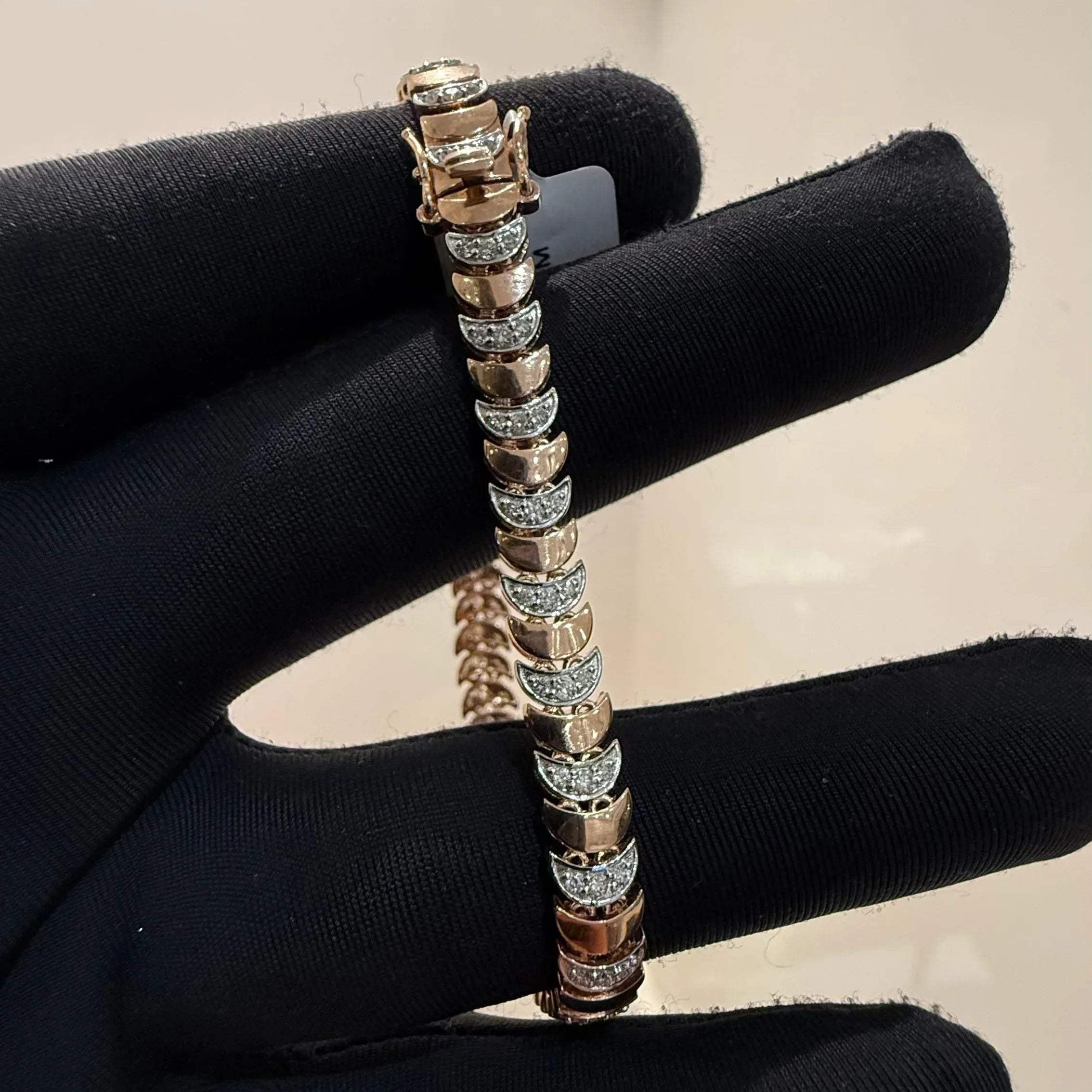 Elegant gold diamond bracelet crafted with unique crescent links and sparkling pavé-set diamonds.