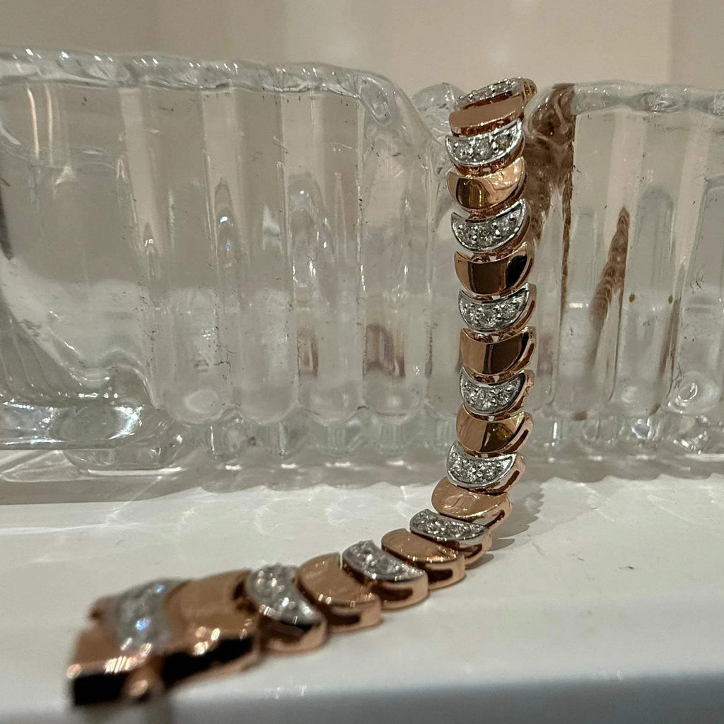 Elegant gold diamond bracelet crafted with unique crescent links and sparkling pavé-set diamonds.