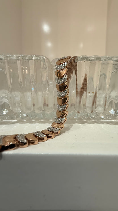 Elegant gold diamond bracelet crafted with unique crescent links and sparkling pavé-set diamonds.