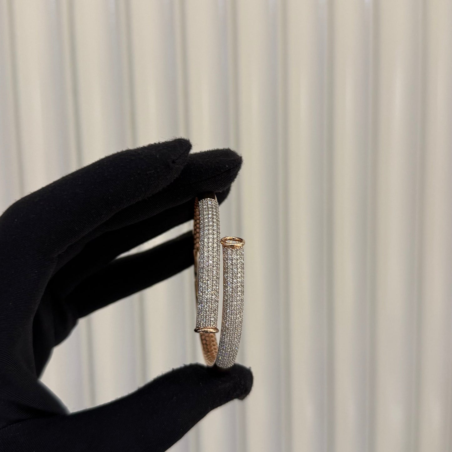 Luxury rose gold diamond bracelet featuring multiple rows of sparkling diamonds in a stylish cuff shape.