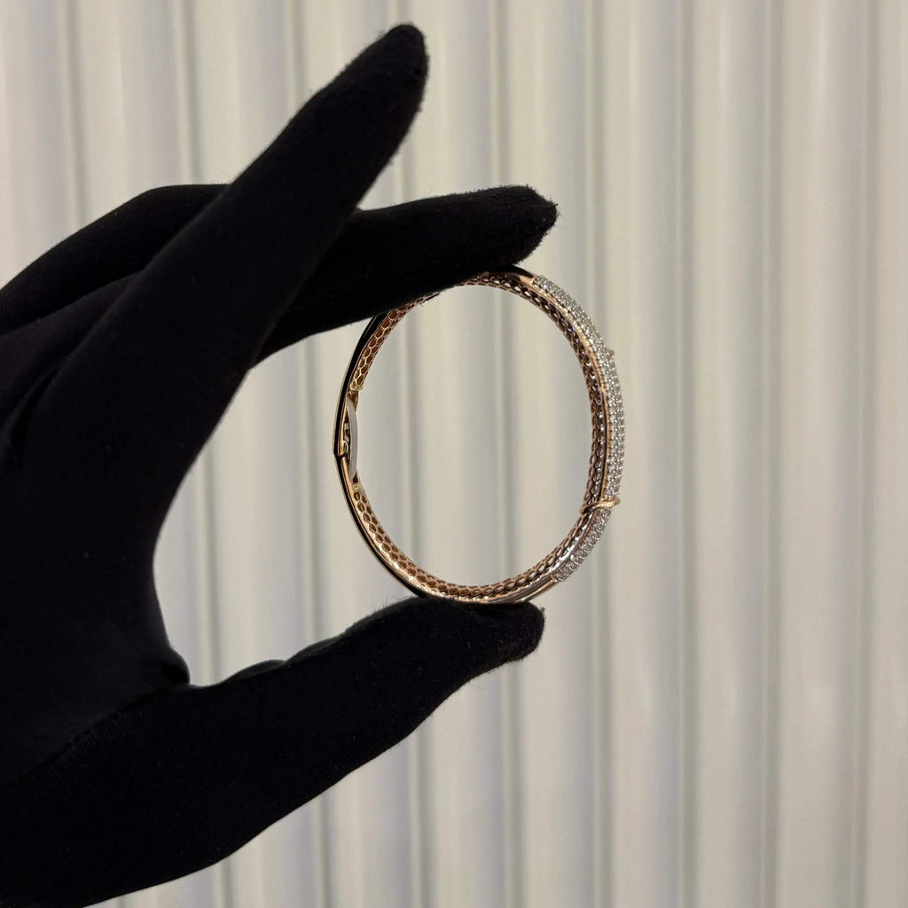 Luxury gold diamond bracelet featuring multiple rows of sparkling diamonds in a stylish cuff shape.