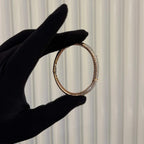 Luxury gold diamond bracelet featuring multiple rows of sparkling diamonds in a stylish cuff shape.
