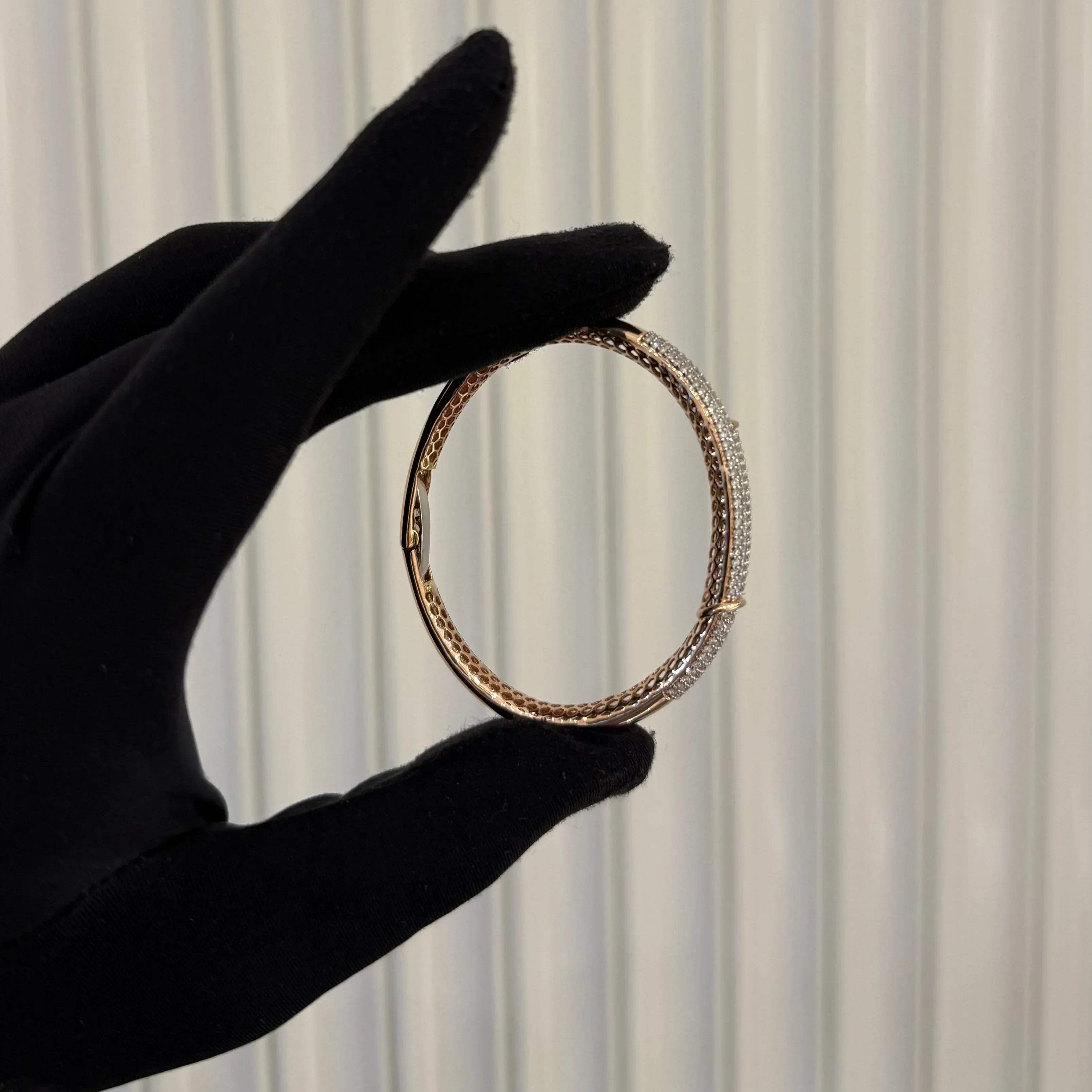 Luxury gold diamond bracelet featuring multiple rows of sparkling diamonds in a stylish cuff shape.