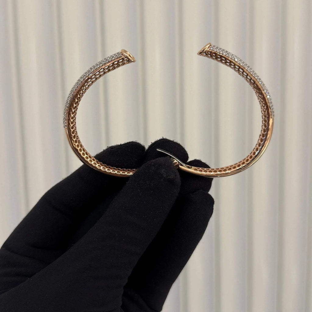 Luxury gold diamond bracelet featuring multiple rows of sparkling diamonds in a stylish cuff shape.