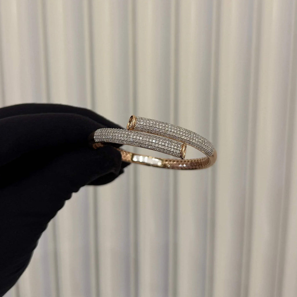 Luxury gold diamond bracelet featuring multiple rows of sparkling diamonds in a stylish cuff shape.