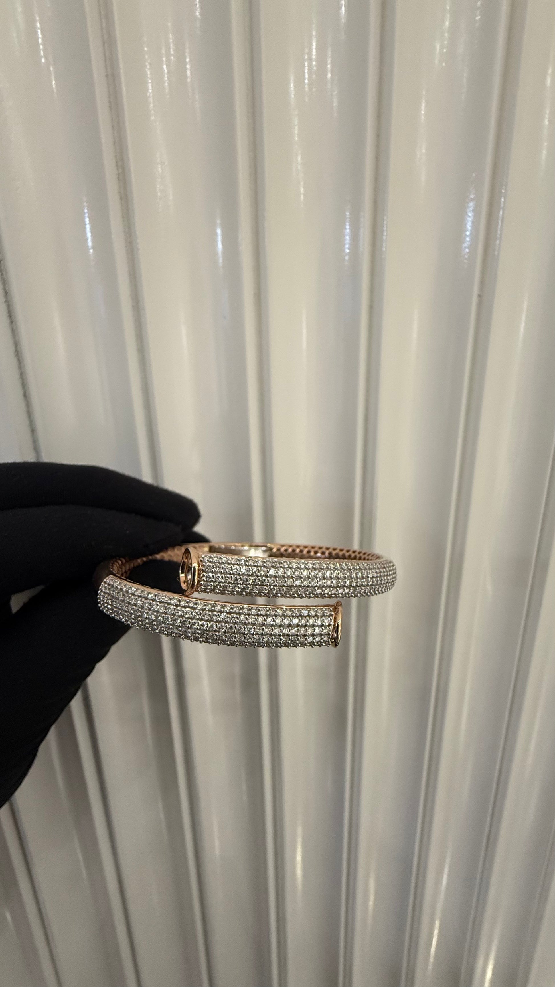Luxury gold diamond bracelet featuring multiple rows of sparkling diamonds in a stylish cuff shape.
