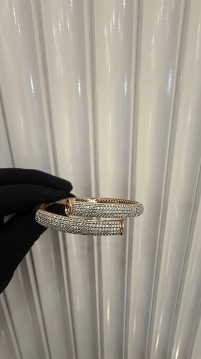 Luxury gold diamond bracelet featuring multiple rows of sparkling diamonds in a stylish cuff shape.