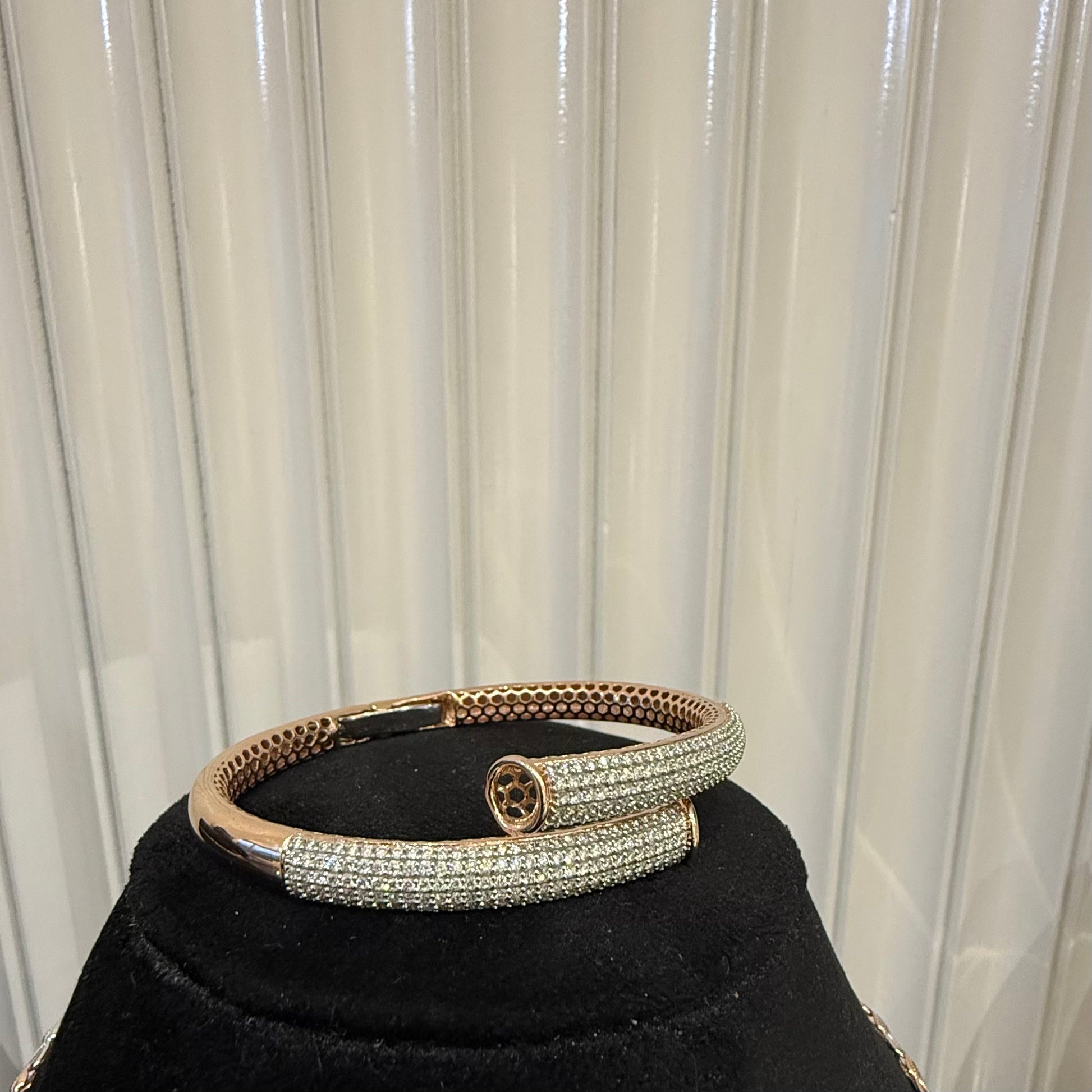 Luxury gold diamond bracelet featuring multiple rows of sparkling diamonds in a stylish cuff shape.