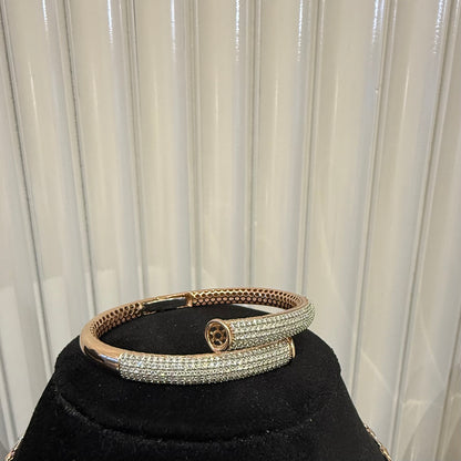Luxury gold diamond bracelet featuring multiple rows of sparkling diamonds in a stylish cuff shape.